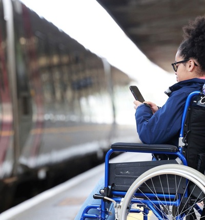 Young Female Wheelchair User At Train Station