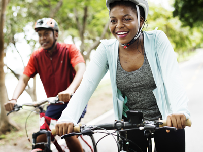 A man and woman happily cycling
