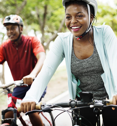 A man and woman happily cycling
