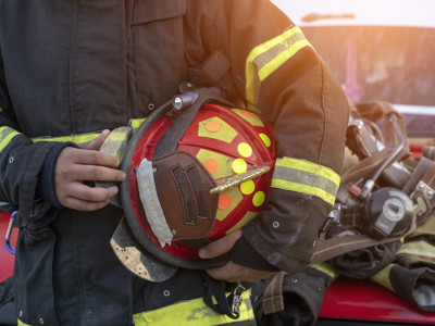 Fireman holding helmet