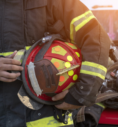 Fireman holding helmet
