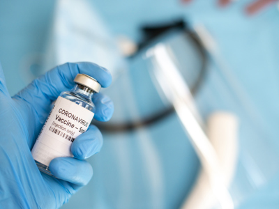 A doctor's hand with a syringe of covid-19 coronavirus vaccine