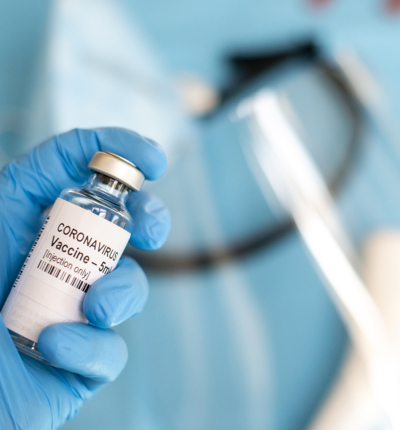 A doctor's hand with a syringe of covid-19 coronavirus vaccine