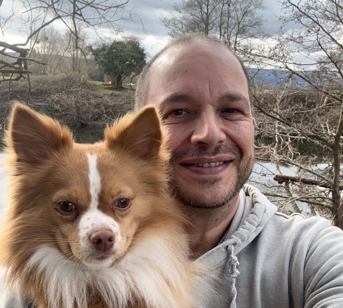 Gino and his dog, a pomeranian mix, in front of the river wye