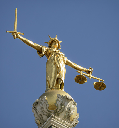 The gold bronze Lady Justice statue with sword and scales above the Central Criminal Court, Old Bailey, London