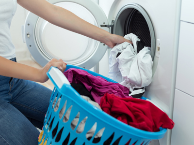 Woman Loading Washing Machine