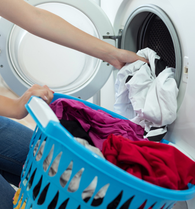 Woman Loading Washing Machine