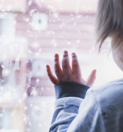 Little boy looking out of the window