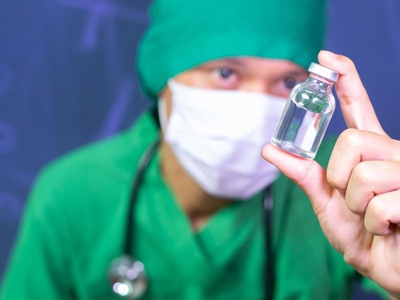 Doctor Holding Vaccine Phial