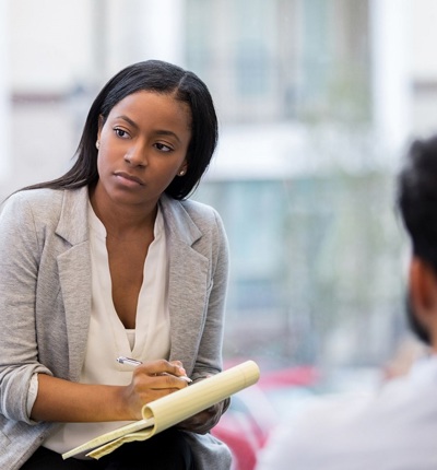 Woman Listening Taking Notes