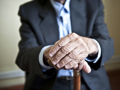 Anonymous Elderly Man Holding Stick