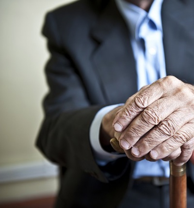 Anonymous Elderly Man Holding Stick