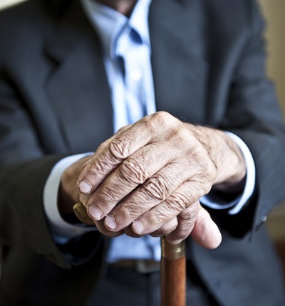 Anonymous Elderly Man Holding Stick