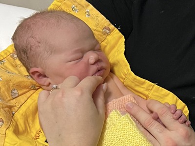 Newborn baby in yellow blanket