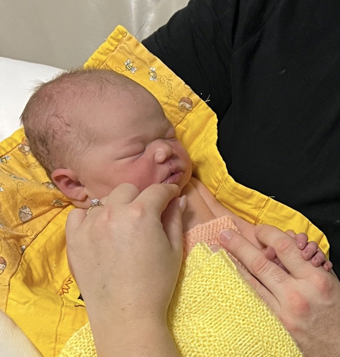 newborn baby in yellow blanket
