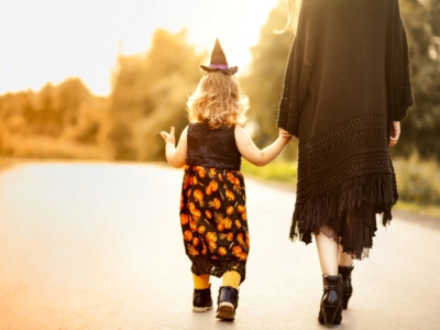 Child In Halloween Costume With Parent