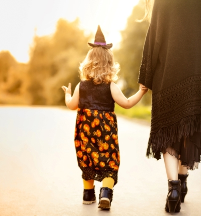 Child In Halloween Costume With Parent