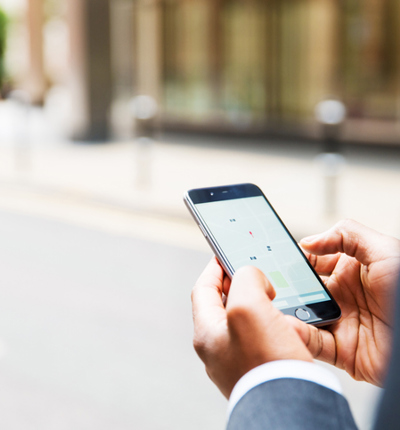 Close up of businessman using taxi app - stock photo