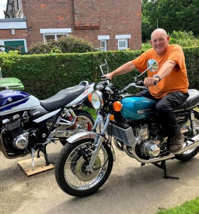 Tom Frith, sitting on a motorbike in his garden
