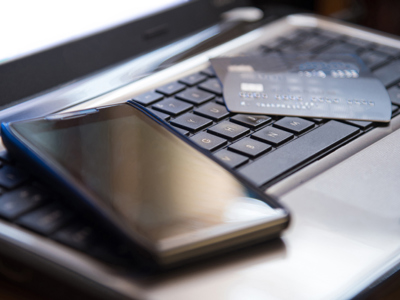 Phone and credit card on laptop keyboard