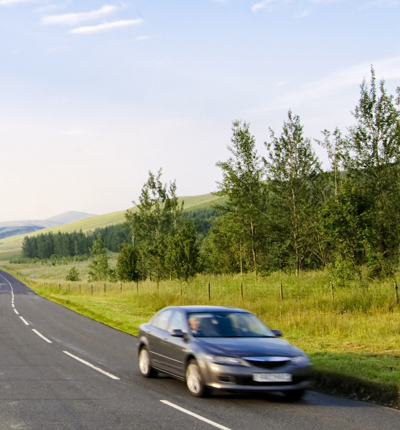 Car moving along country road