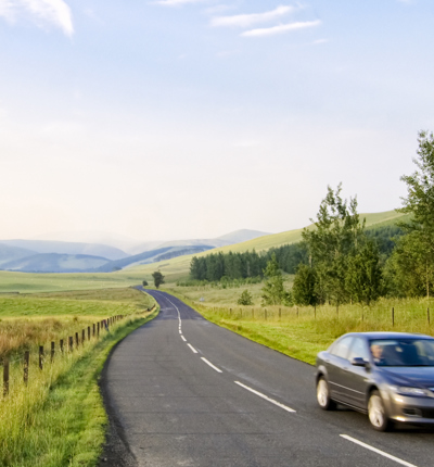 Car moving along country road