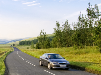 Car moving along country road