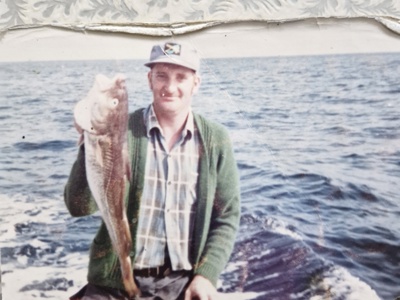 Walter Freeman pictured in the mid 1970s holding a large fish upon a raft