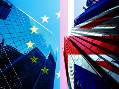 Skyscrapers reflected on EU and UK flags