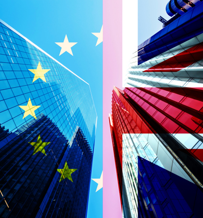 Skyscrapers reflected on EU and UK flags