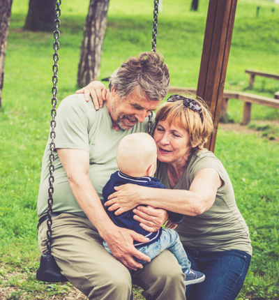 Elderly white couple with grandchild in park