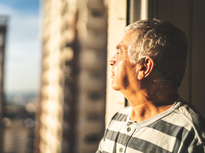 man looking out the window