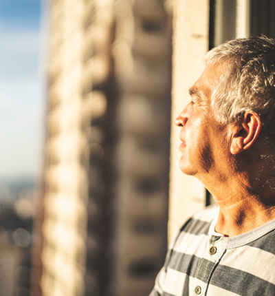 man looking out the window