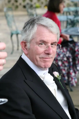 David Pitfield, a man with grey hair and glasses wearing a tuxedo