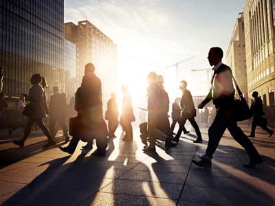 Employees walking to work in the city at sunrise