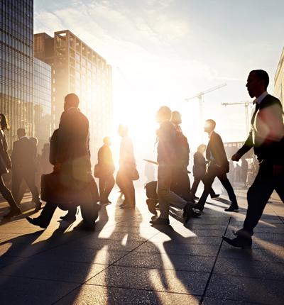 Employees walking to work in the city at sunrise