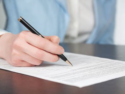 Woman in suit writing a letter
