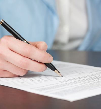 Woman in suit writing a letter