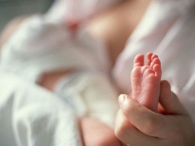 Mother Holding Newborn Foot