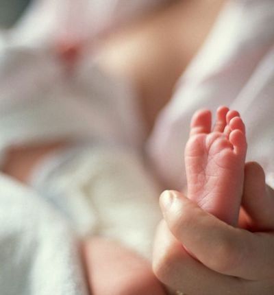 Mother Holding Newborn Foot