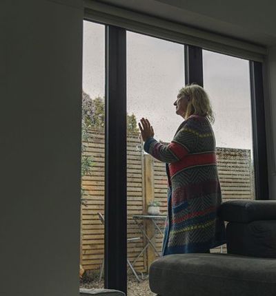Woman Looking Out Of Window