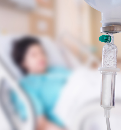 Medical drip with patient in the hospital blurred background