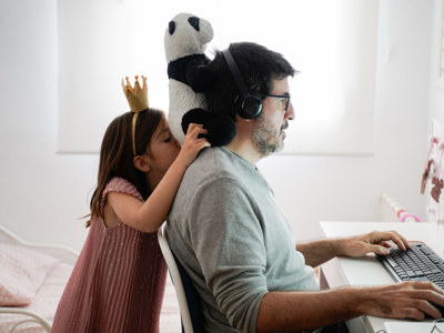 man working on computer with daughter
