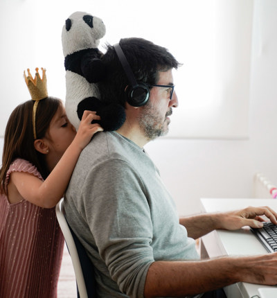 man working on computer with daughter