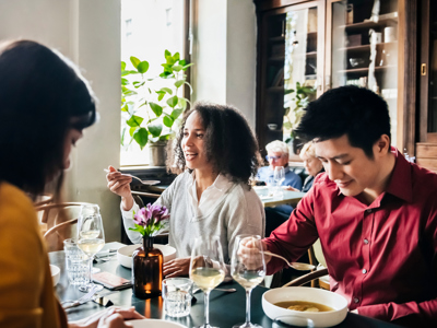 Group Of Friends Eating Lunch Together In Restaurant