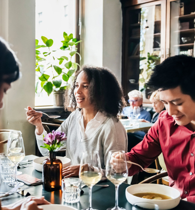 Group Of Friends Eating Lunch Together In Restaurant