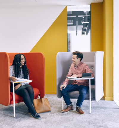 Two people sat in chairs facing each other