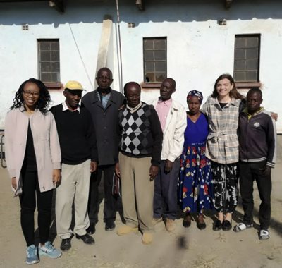 2 Leigh Day staff with 6 Zambian villagers looking at the camera
