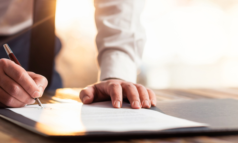 Man Signing A Document