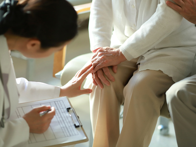 Doctor Checking Patient's Knee Pain